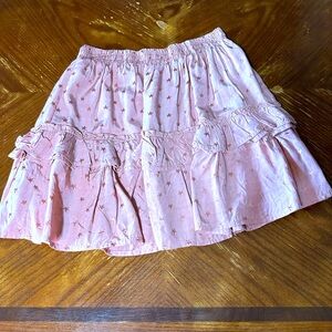 Pink skirt with stars on it.